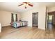 Spacious bedroom with wood-look floors, a ceiling fan, and ensuite bath at 85 Riley Dr, Taylorsville, NC 28681