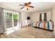 Spacious bedroom with wood-look floors, a ceiling fan, and sliding glass door at 85 Riley Dr, Taylorsville, NC 28681