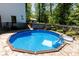 Backyard pool featuring a deck and surrounded by mature trees at 85 Riley Dr, Taylorsville, NC 28681