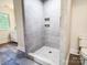 Modern tile shower with built-in shelving and updated fixtures at 85 Riley Dr, Taylorsville, NC 28681