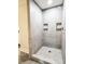 Modern tiled shower features built-in shelves and a rainfall shower head at 85 Riley Dr, Taylorsville, NC 28681