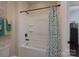 Bright bathroom featuring a tub with shower, a colorful curtain and wall decorations at 866 Tyne Dr, Fort Mill, SC 29715