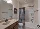Bathroom featuring a vanity with bronze fixtures and a shower and tub with decorative curtain at 866 Tyne Dr, Fort Mill, SC 29715