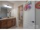 Bathroom with double sink vanity, wood cabinets, and tile flooring, opens to second bathroom at 866 Tyne Dr, Fort Mill, SC 29715