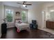 Cozy bedroom with a twin bed, two windows, and dark wood flooring, next to bathroom at 866 Tyne Dr, Fort Mill, SC 29715