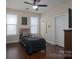 Well-lit bedroom with hardwood floors, two windows, and a ceiling fan at 866 Tyne Dr, Fort Mill, SC 29715