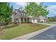 A well maintained home with a green lawn, healthy landscaping, and easy access to neighborhood sidewalks at 866 Tyne Dr, Fort Mill, SC 29715