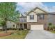 Charming two-story brick home with a well-manicured lawn and attached two-car garage, offering curb appeal at 866 Tyne Dr, Fort Mill, SC 29715