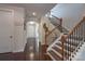 Bright foyer featuring hardwood floors, staircase with decorative railing, and arched doorway, creating a welcoming entrance at 866 Tyne Dr, Fort Mill, SC 29715