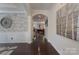 Elegant foyer with hardwood floors, stone accent wall, decorative art, and an arched entryway leading to other rooms at 866 Tyne Dr, Fort Mill, SC 29715