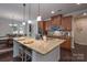 Bright kitchen with a large center island, seating, granite countertops, and stylish pendant lighting for a contemporary feel at 866 Tyne Dr, Fort Mill, SC 29715