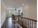 Upstairs living area with hardwood floors, built-in shelves, and a staircase at 866 Tyne Dr, Fort Mill, SC 29715