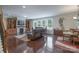 Spacious living room features a stone fireplace, hardwood floors, and large windows for natural light at 866 Tyne Dr, Fort Mill, SC 29715