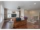 Inviting living room with built-in shelving, a comfortable leather sofa, and hardwood flooring at 866 Tyne Dr, Fort Mill, SC 29715