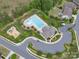 Aerial view of the community pool, playground, clubhouse, parking and green spaces, perfect for Gathering fun and recreation at 866 Tyne Dr, Fort Mill, SC 29715