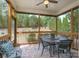 Inviting screened porch with comfortable seating, table, and a view of the landscaped backyard at 866 Tyne Dr, Fort Mill, SC 29715
