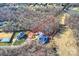 Aerial view of an estate home showcasing the pool, landscaping, and partially wooded lot at 8716 Ruby Hill Ct, Waxhaw, NC 28173