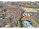 Aerial view of a modern estate with a partially wooded lot with mature trees and landscaping at 8716 Ruby Hill Ct, Waxhaw, NC 28173