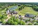 Comprehensive aerial shot of the estate, highlighting the house, golf course, and additional amenities at 8716 Ruby Hill Ct, Waxhaw, NC 28173