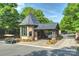 Elegant stone and slate community entrance with a security gatehouse and well-maintained landscaping at 8716 Ruby Hill Ct, Waxhaw, NC 28173