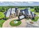 Magnificent home with circular driveway, fountain, lush landscaping, and beautiful stone and shingle exterior at 8716 Ruby Hill Ct, Waxhaw, NC 28173