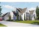 Elegant home features a long driveway and manicured landscaping, plus a three-car garage at 8716 Ruby Hill Ct, Waxhaw, NC 28173