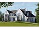 A striking home with stone and painted siding, showcasing professionally landscaped yard at 8716 Ruby Hill Ct, Waxhaw, NC 28173