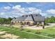 Well-maintained golf facilities, including a practice area with seating, enhancing the golf experience at 8716 Ruby Hill Ct, Waxhaw, NC 28173