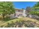 Spacious backyard featuring a patio, lush lawn, mature trees, and partial fencing at 8919 Oransay Way, Charlotte, NC 28278