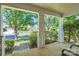 View from the covered front porch showcasing the serene neighborhood, lush greenery, and mature trees at 8919 Oransay Way, Charlotte, NC 28278