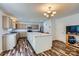 Spacious kitchen featuring an island, stainless steel appliances, and stylish wood-look floors at 8919 Oransay Way, Charlotte, NC 28278