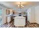Spacious kitchen featuring an island, stainless steel appliances, and stylish wood-look floors at 8919 Oransay Way, Charlotte, NC 28278