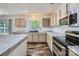 Bright kitchen with stainless steel appliances, an island, plenty of cabinets, and wood-look flooring at 8919 Oransay Way, Charlotte, NC 28278