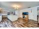 Bright kitchen features gray cabinets, a center island with white cabinets, and wood flooring at 8919 Oransay Way, Charlotte, NC 28278