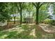 View of the home's private backyard featuring a fire pit and patio area perfect for outdoor entertaining at 8936 Rittenhouse Cir, Charlotte, NC 28270