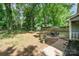 Wide shot of a private backyard with a patio set, a large grassy area, and a shed for storage at 8936 Rittenhouse Cir, Charlotte, NC 28270