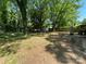 Spacious backyard with a patio area, shade trees, storage shed and a privacy fence, perfect for outdoor living at 8936 Rittenhouse Cir, Charlotte, NC 28270