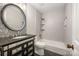 Modern bathroom with unique mosaic floors, a granite vanity, and a shower-tub combination at 8936 Rittenhouse Cir, Charlotte, NC 28270