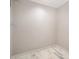 Empty walk-in closet features marble floors and hanging racks at 8936 Rittenhouse Cir, Charlotte, NC 28270