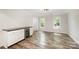 Bright dining area featuring wood-look floors, white cabinets, and a built-in wine fridge for entertaining at 8936 Rittenhouse Cir, Charlotte, NC 28270