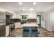 Stylish kitchen offers wood countertops, black tile backsplash, island with seating, and stainless steel appliances at 8936 Rittenhouse Cir, Charlotte, NC 28270