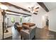 Cozy living room with exposed beams, a fireplace, and comfortable seating, perfect for relaxing at 8936 Rittenhouse Cir, Charlotte, NC 28270