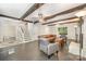 Spacious living room featuring exposed beams, tile floors, and ample natural light at 8936 Rittenhouse Cir, Charlotte, NC 28270