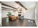 Open living room with exposed beams, fireplace, tile flooring, and ample seating for entertaining at 8936 Rittenhouse Cir, Charlotte, NC 28270