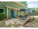 Backyard patio with a dining set, a small garden, and a door with an artistic mural at 8936 Rittenhouse Cir, Charlotte, NC 28270