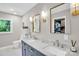 Bright bathroom features a double vanity with marble countertop and view into walk-in closet at 9809 Hanover Hollow Dr, Charlotte, NC 28210