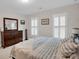 Comfortable bedroom with natural light featuring wood dresser and tranquil ambiance at 9809 Hanover Hollow Dr, Charlotte, NC 28210