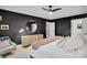 Bright bedroom with black accent wall, carpet, and decorative round mirror at 9809 Hanover Hollow Dr, Charlotte, NC 28210