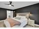 Main bedroom with black accent wall, decorative lighting, and adjoining bathroom at 9809 Hanover Hollow Dr, Charlotte, NC 28210