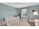 Cozy bedroom with natural light features a twin bed, comfortable seating, and neutral decor at 9809 Hanover Hollow Dr, Charlotte, NC 28210